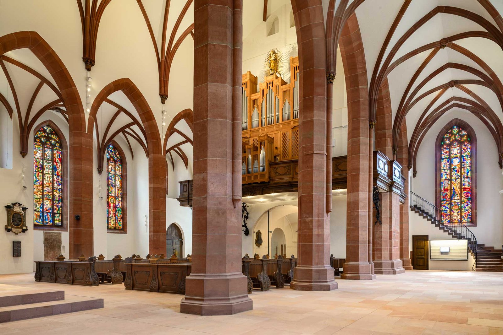 Innenaufnahme der Stiftskirche Baden-Baden mit Blick auf die Orgel und gotische Glasfenster